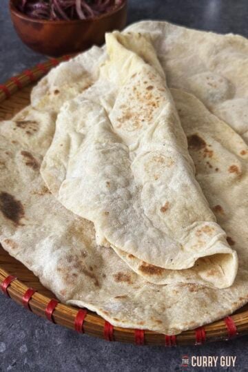 Homemade lavash bread on a serving plate.