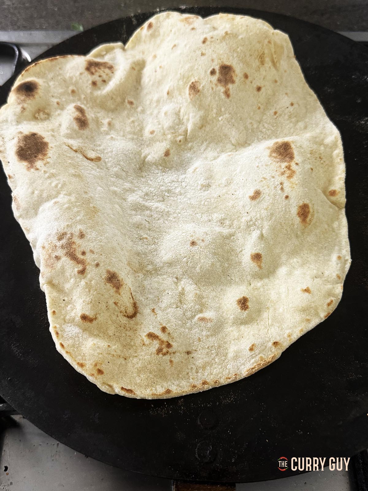 The lavesh flipped over to cook the other side.