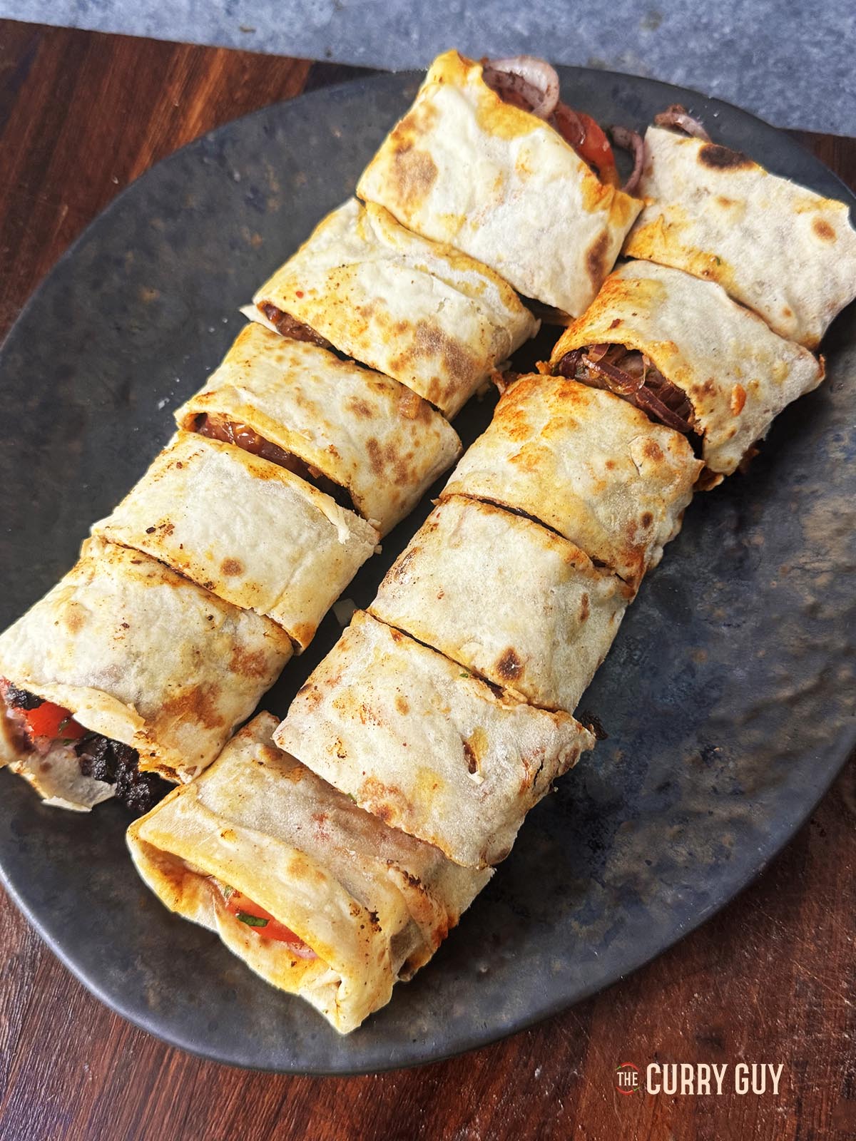 Rolling the tantuni and slicing into bite sized pieces.