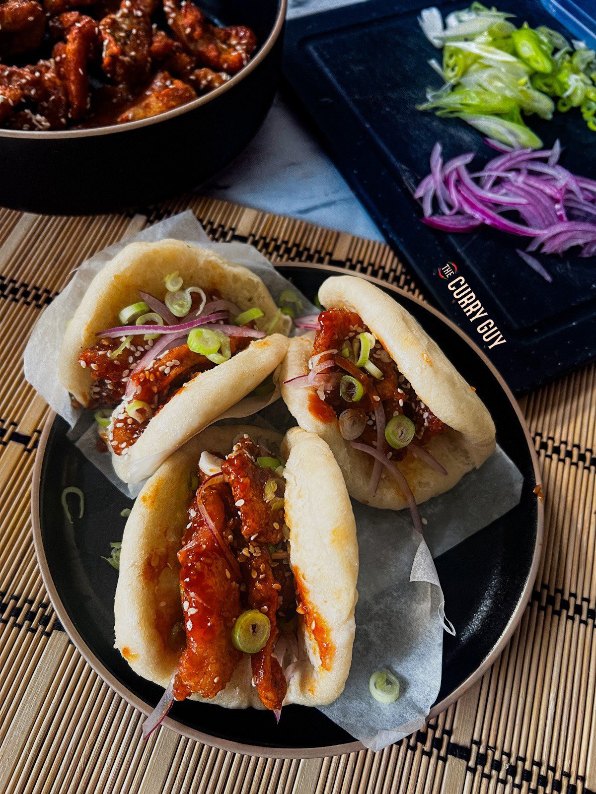 Chicken bao served up on with fresh toppings