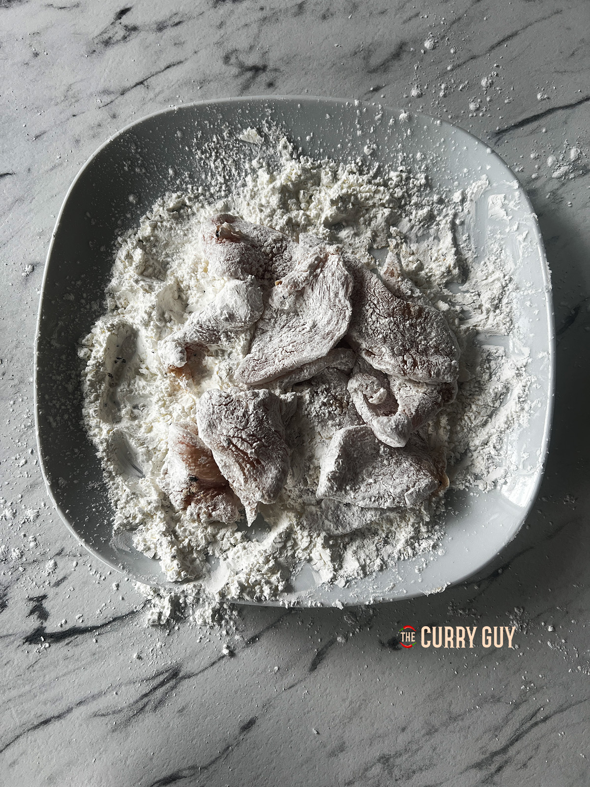 Dusting the chicken in the flour mixture