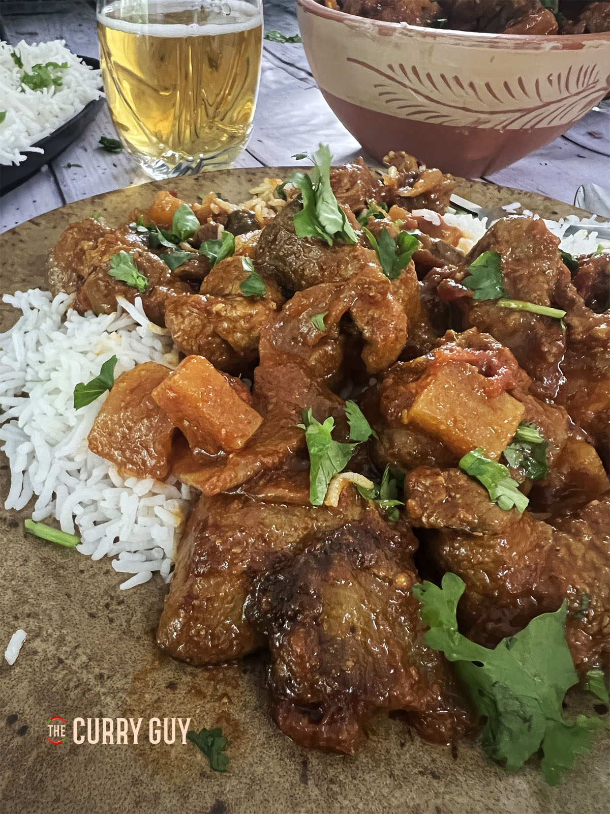 Shalgam Gosht on a serving plate over rice.