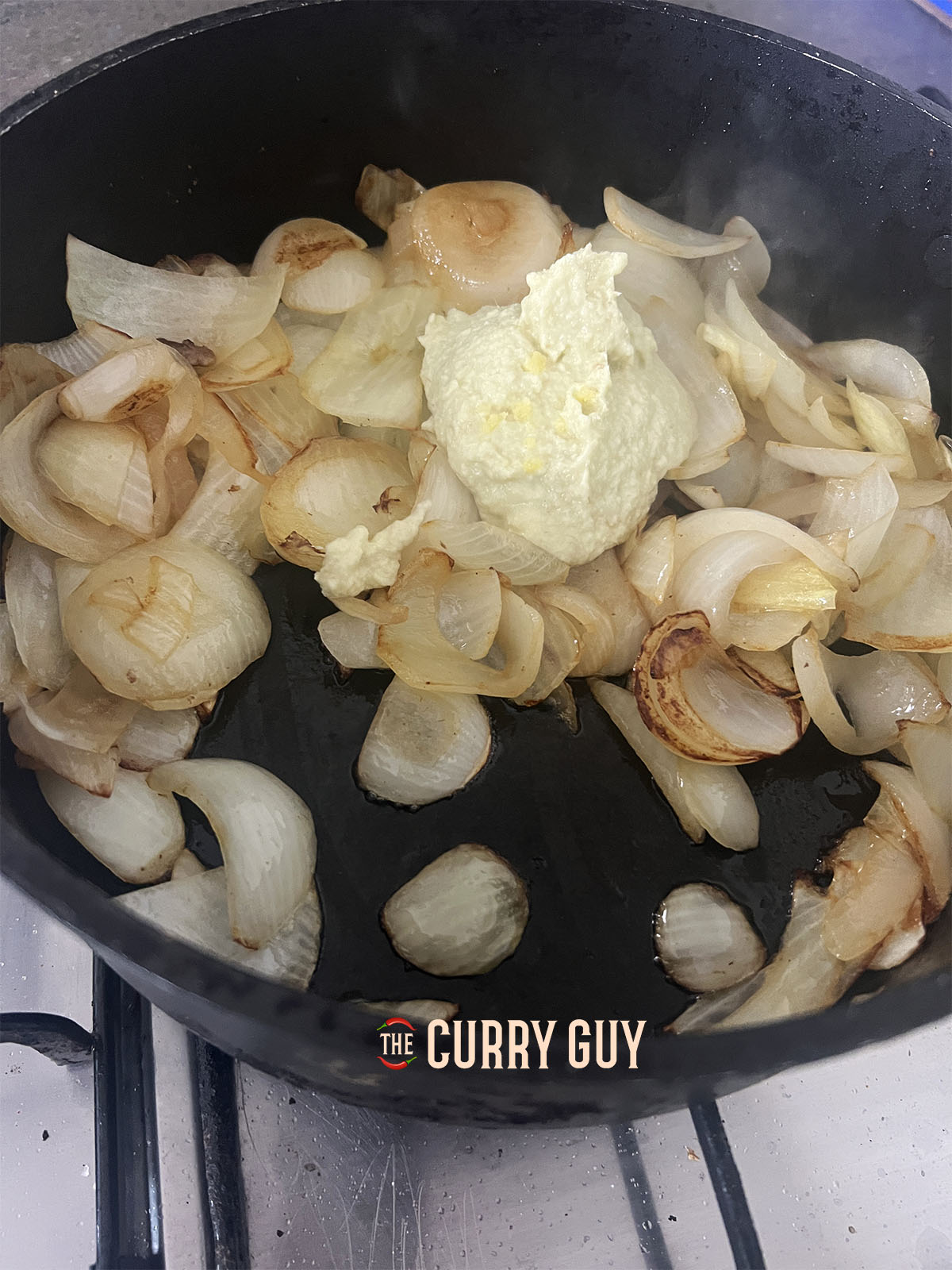 Adding the garlic and ginger paste to the onions. 