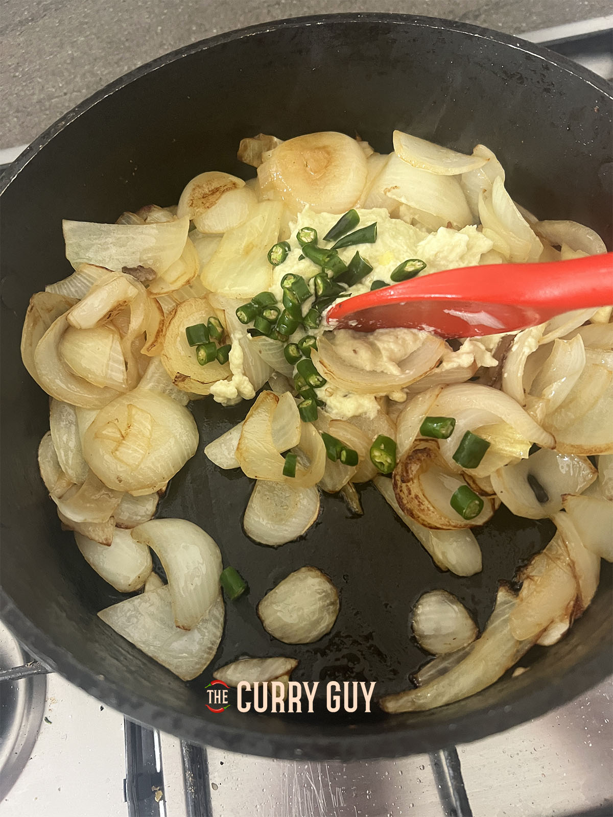 Adding the chopped chillies to the pan.