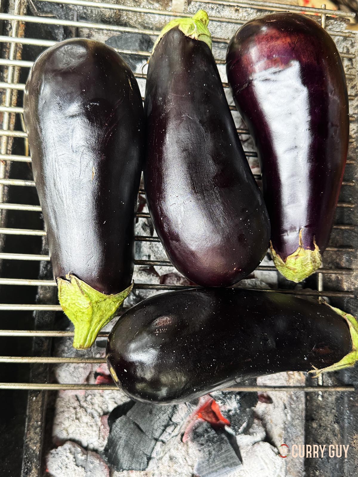 Roasting the aubergines over a charcoal fire. 