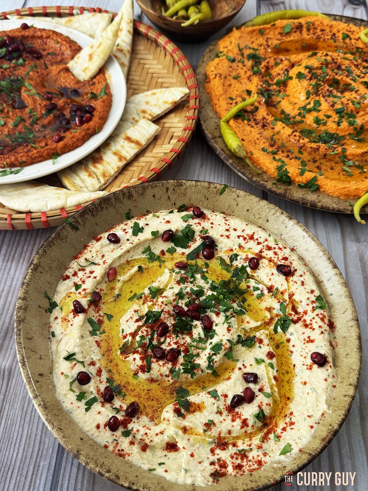 Baba ganoush served with roasted pepper hummus and muhammara.