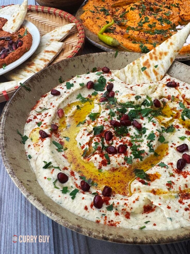 Baba ganoush garnished with pomegranate seeds, parsley, olive oil and aleppo chilli flakes.