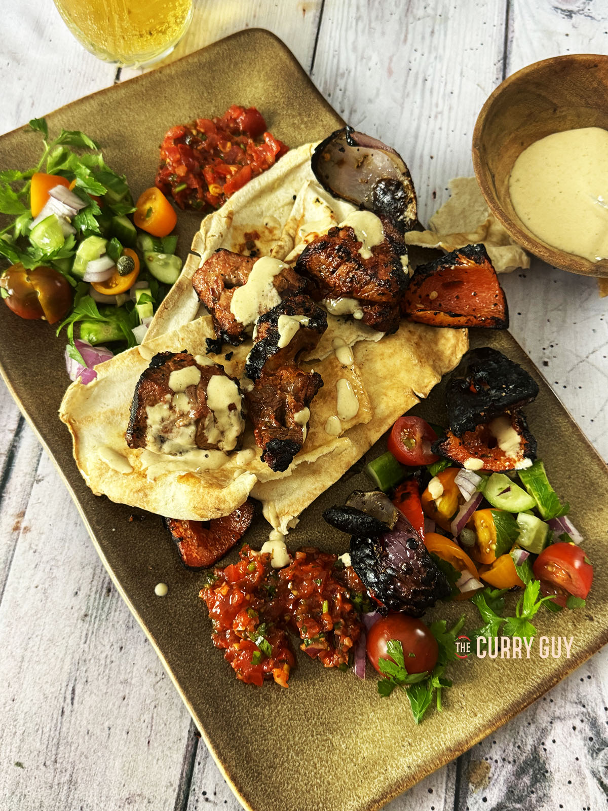 Beef kabobs serve over lavish bread with a number of Turkish mezzes.