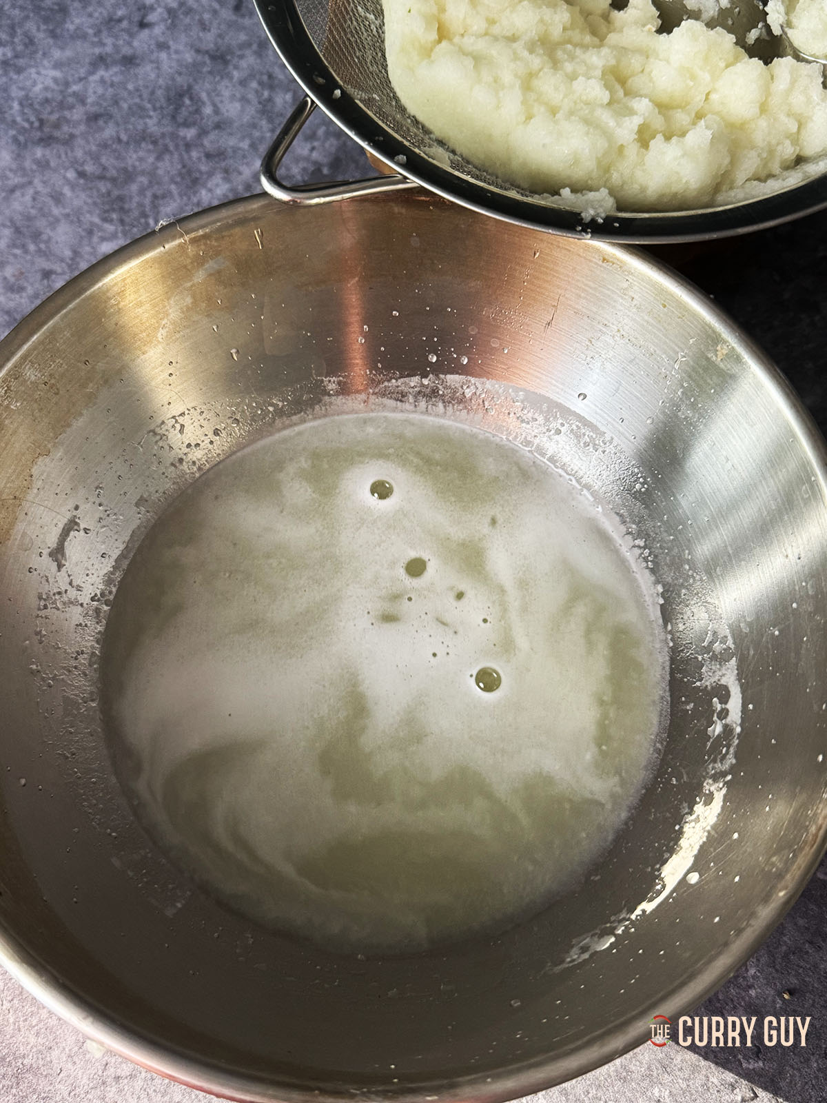 The onion juice produced from the paste.