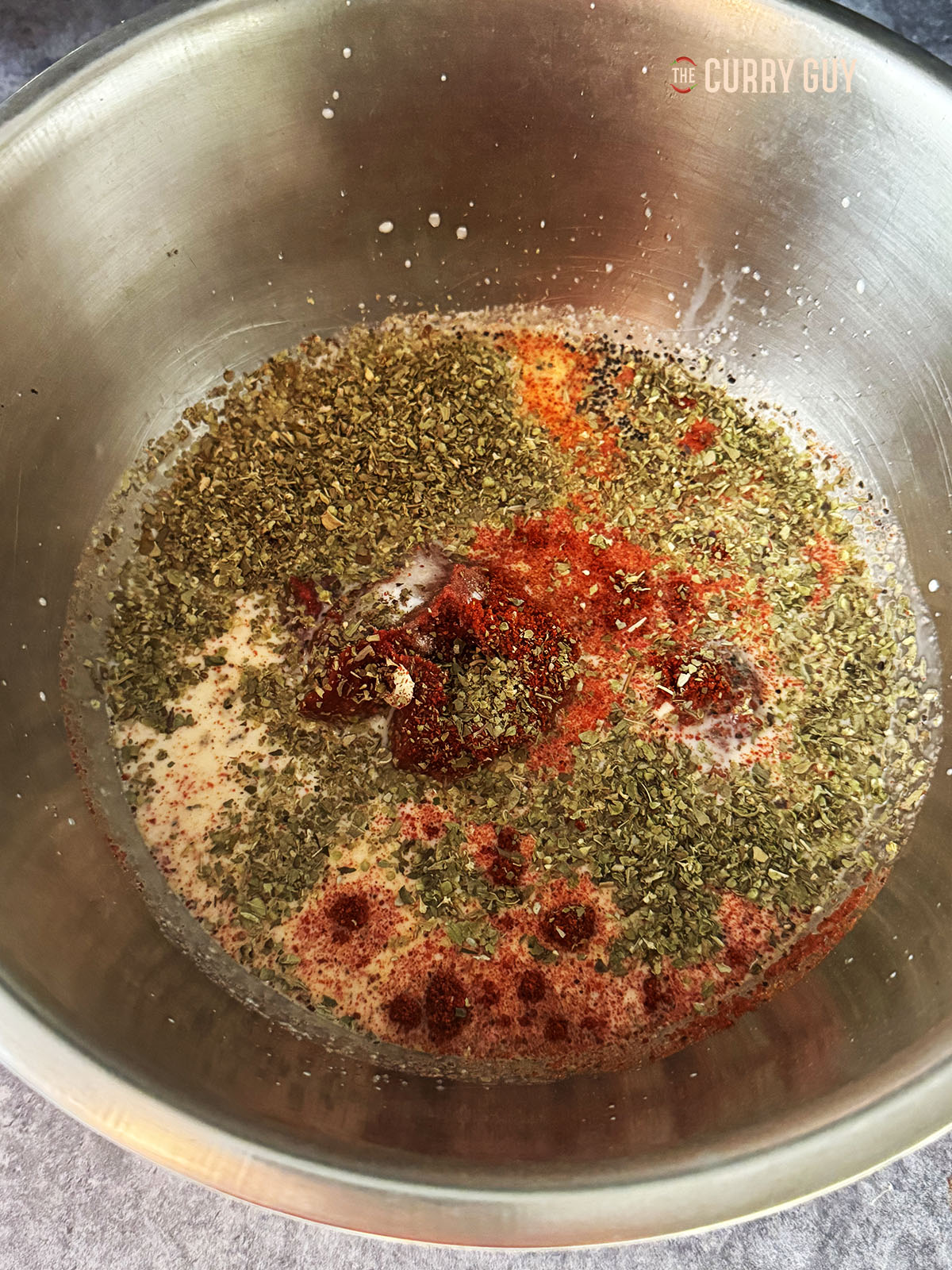 Adding the remaining marinade ingredients to the onion juice.