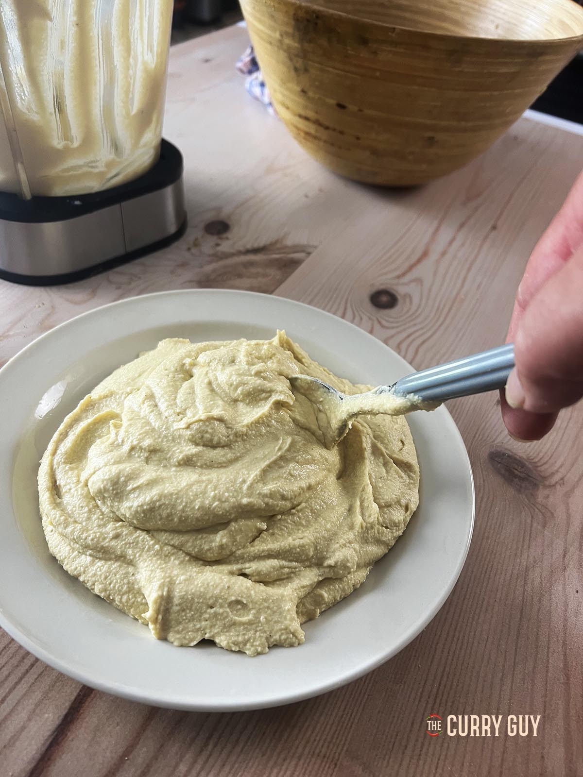 Preparing the hummus on the plate for serving. 