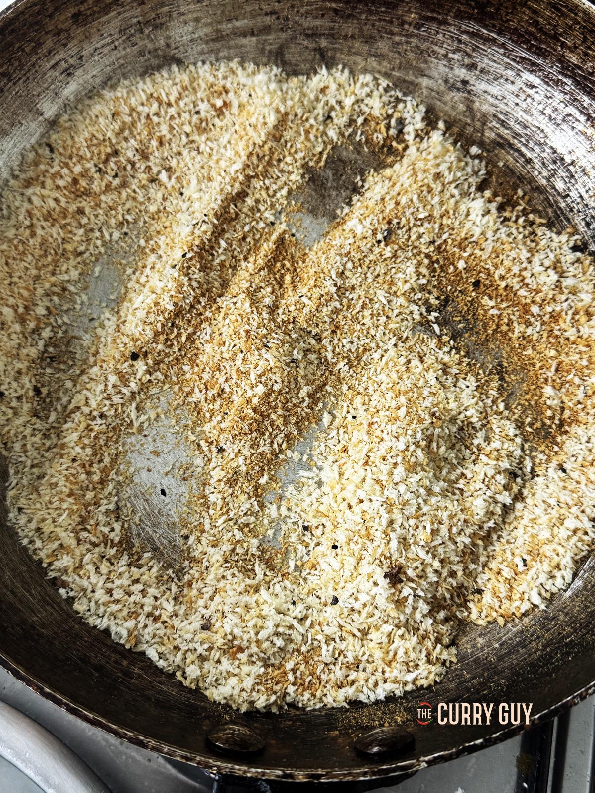 Toasting the breadcrumbs until golden brown in the pan.