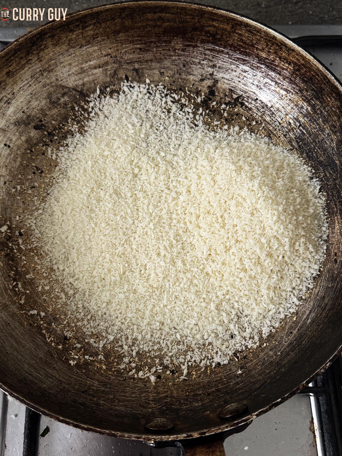 Adding the bread crumbs to the pan.