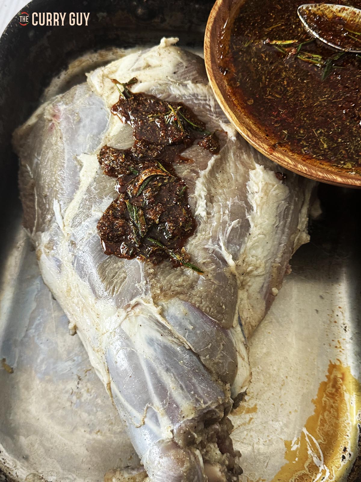 Pouring the second marinade onto the meat. 