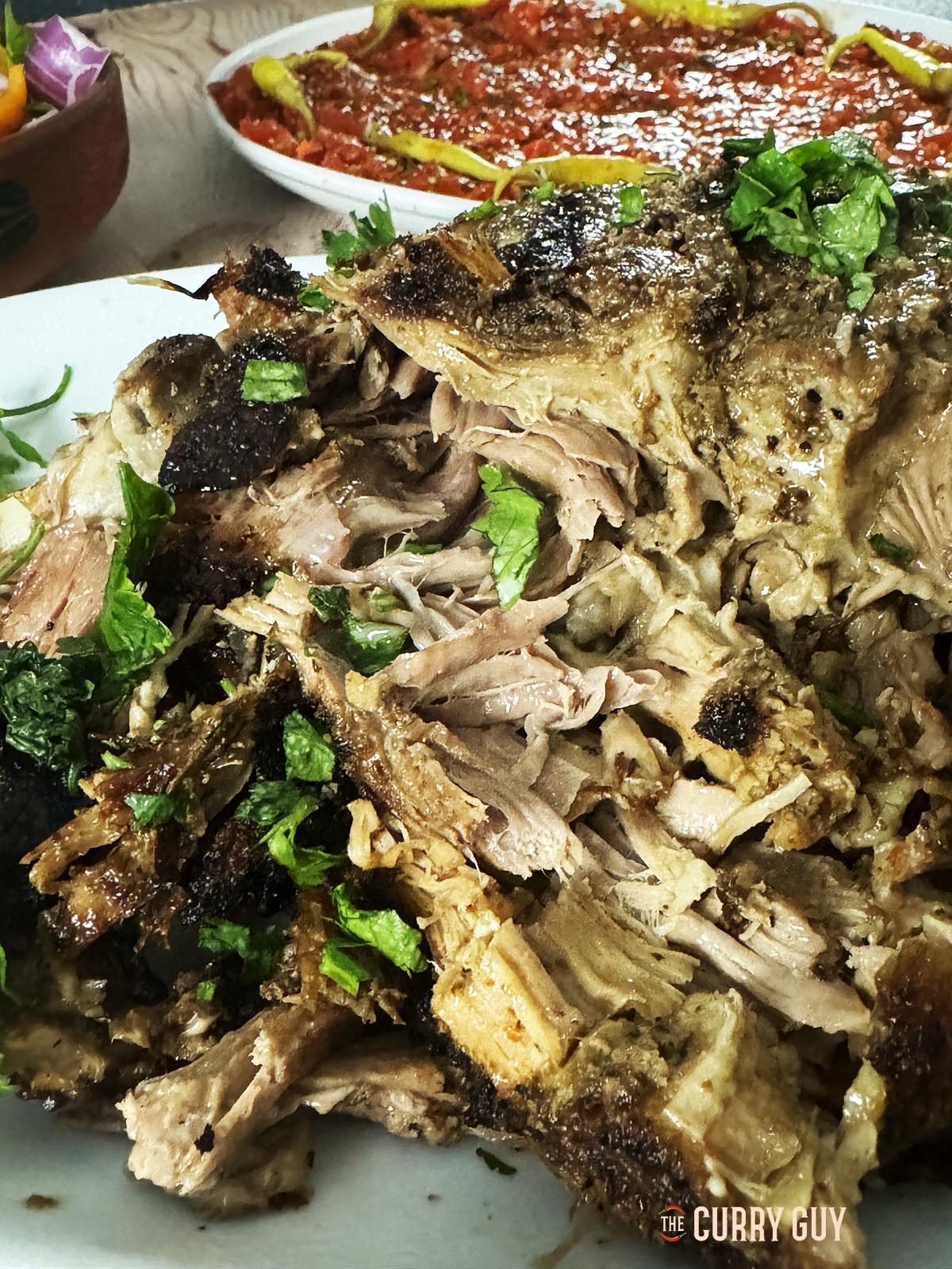 Slow cooked lamb leg pulled apart. Very tender meat.