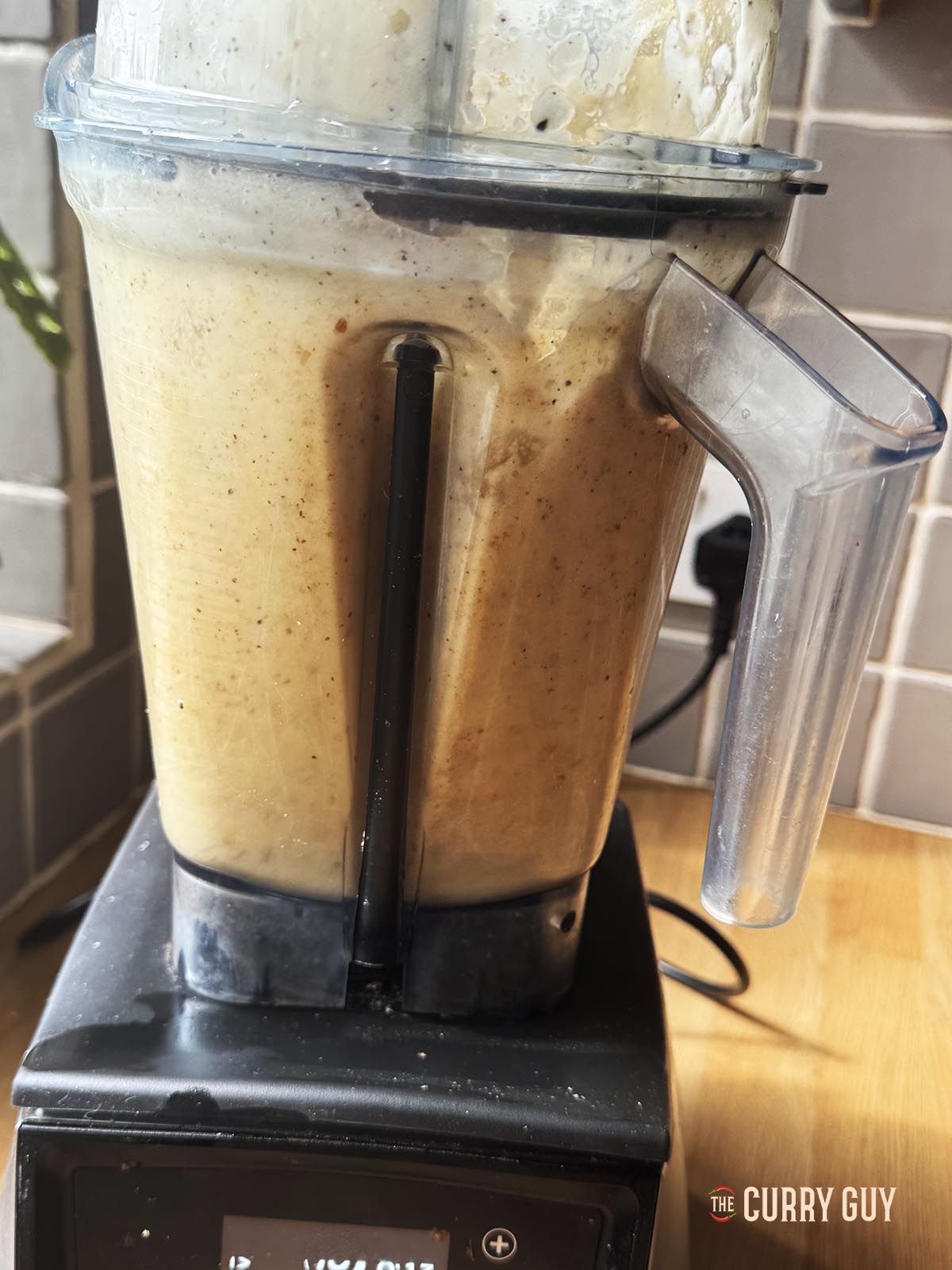 Blending the onions, garlic, peppercorns and water.