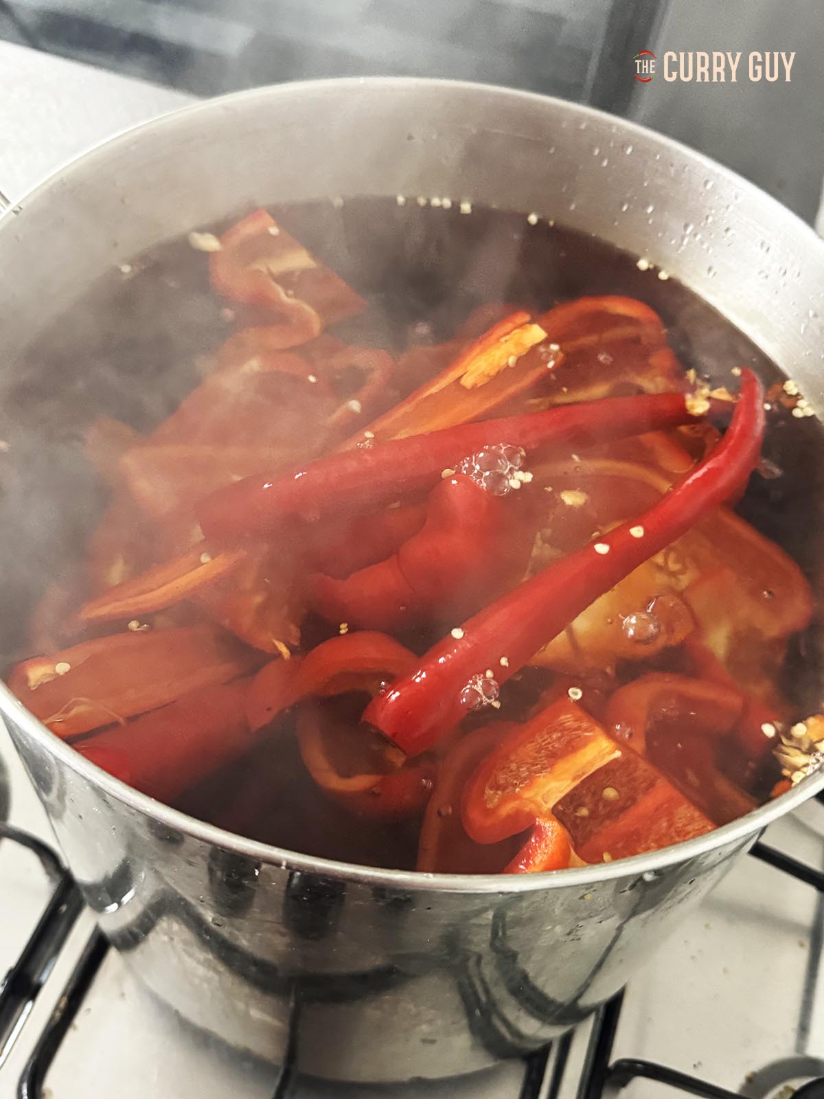 Boiling the peppers in water. 