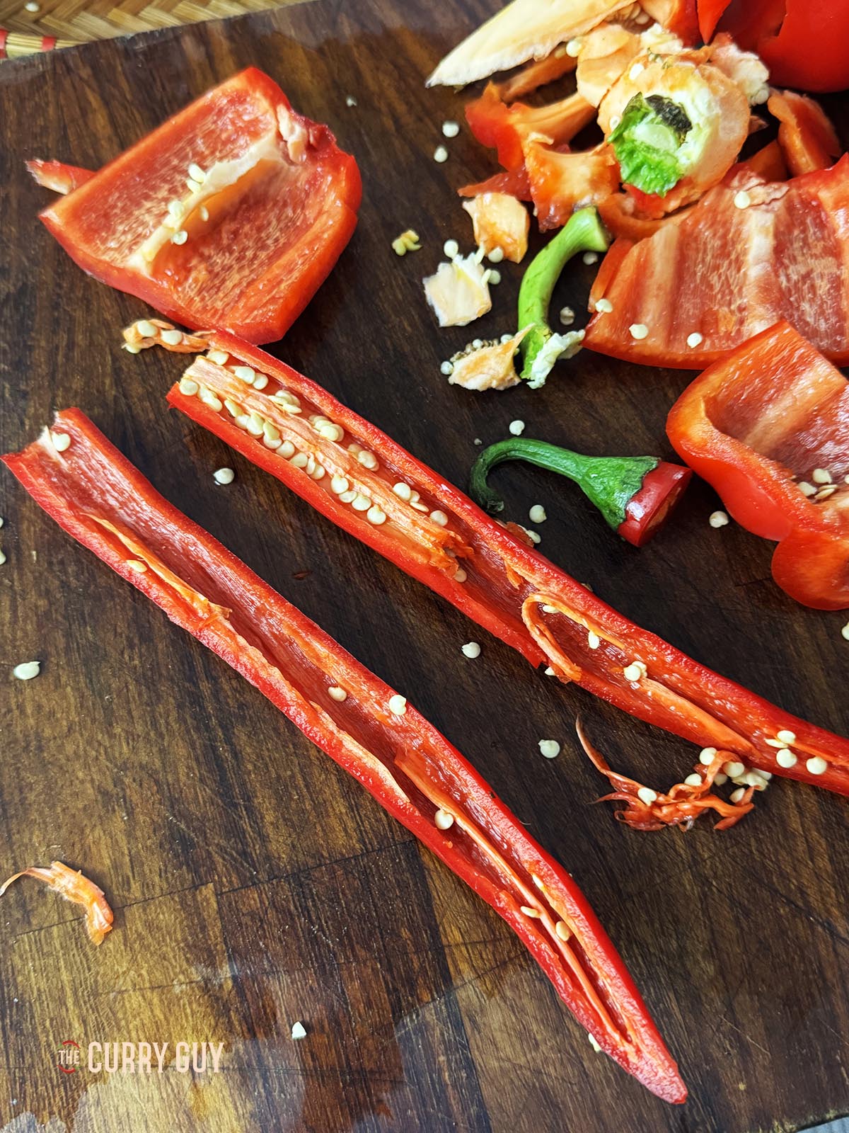 Removing the seeds and membranes from the spicy red chillies. 