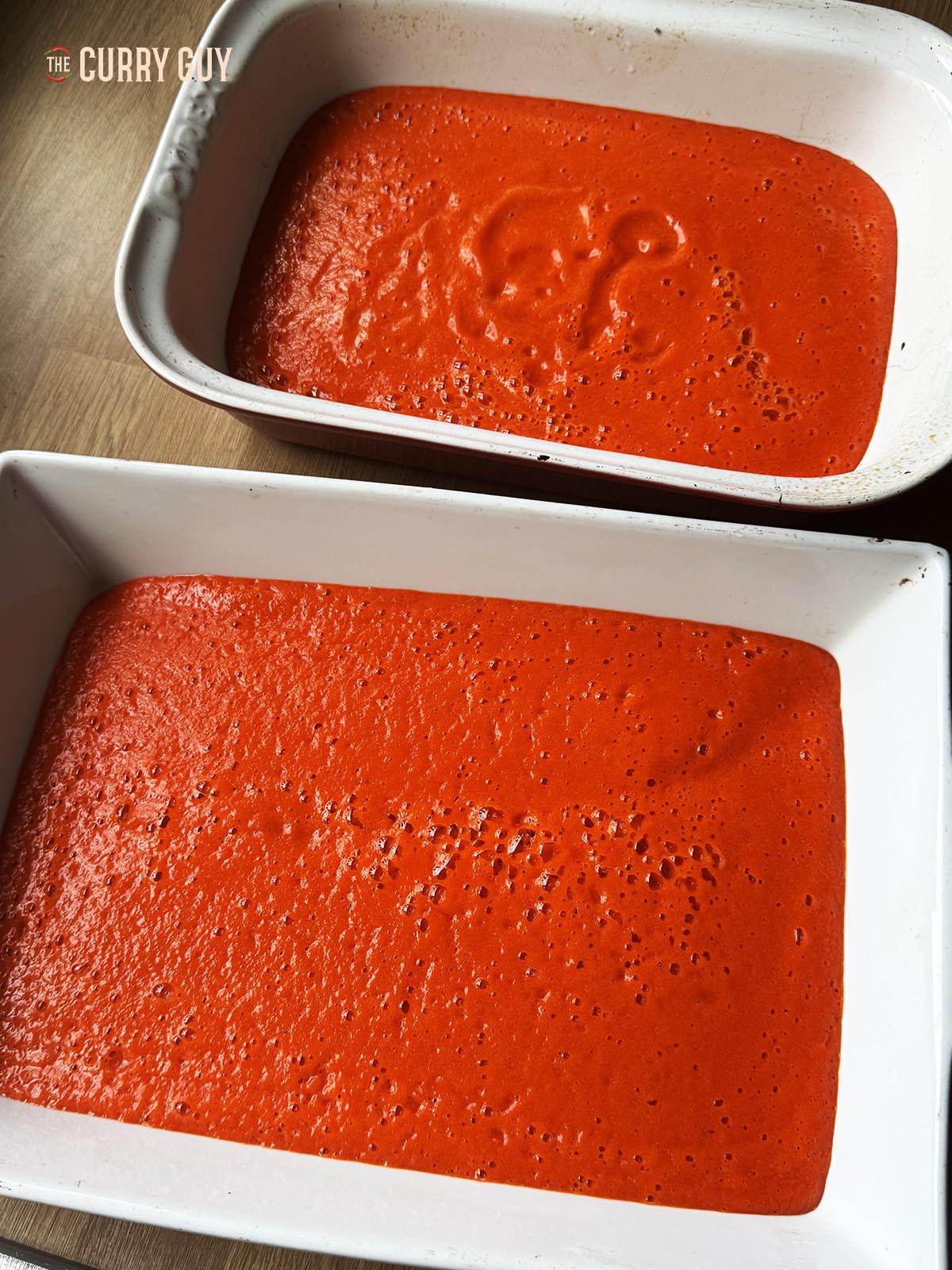The smooth pepper sauce in two baking trays.