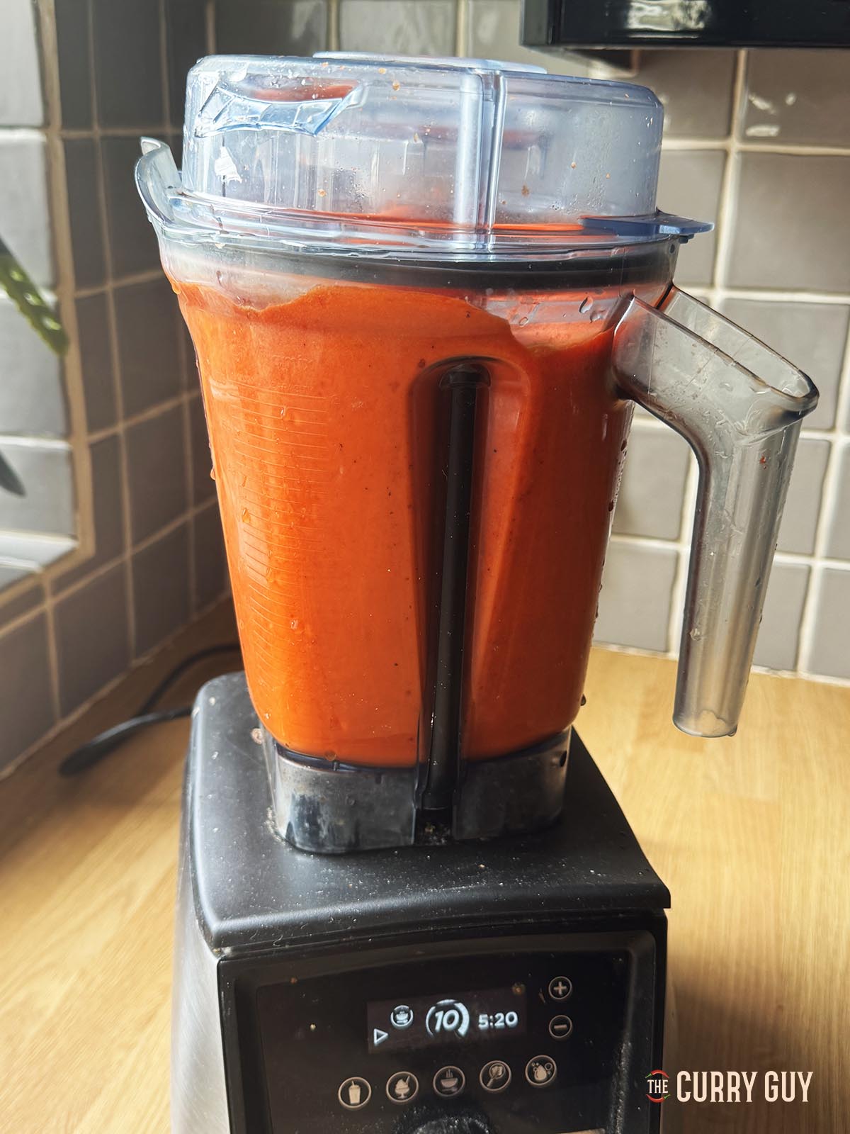 Blending the peppers into a smooth but wet paste.