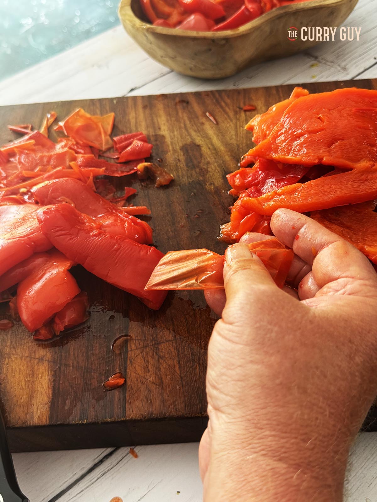 Removing the skins from the chillies and bell peppers.