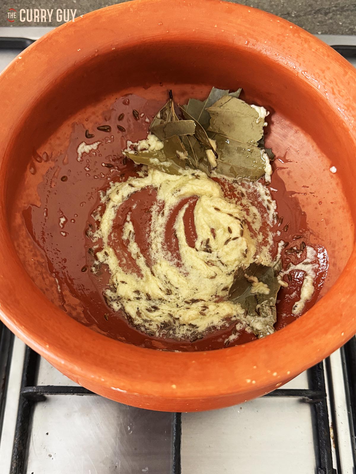 Adding the garlic and ginger paste to the pan.