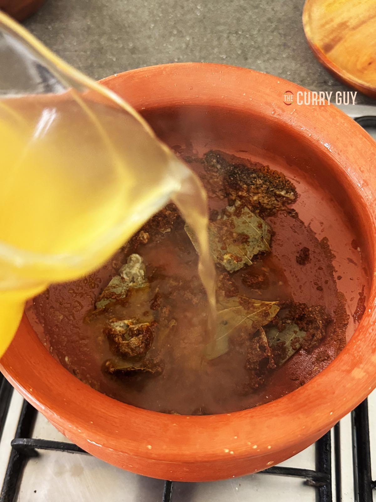 Adding stock to the pan.