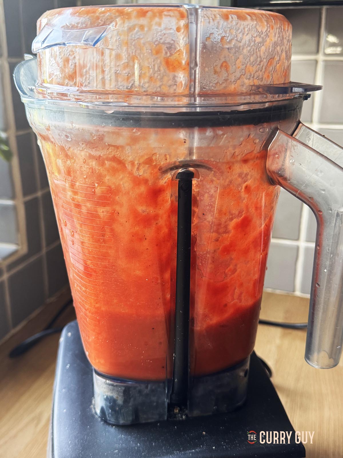 Blending the chopped tomatoes in a blender. 