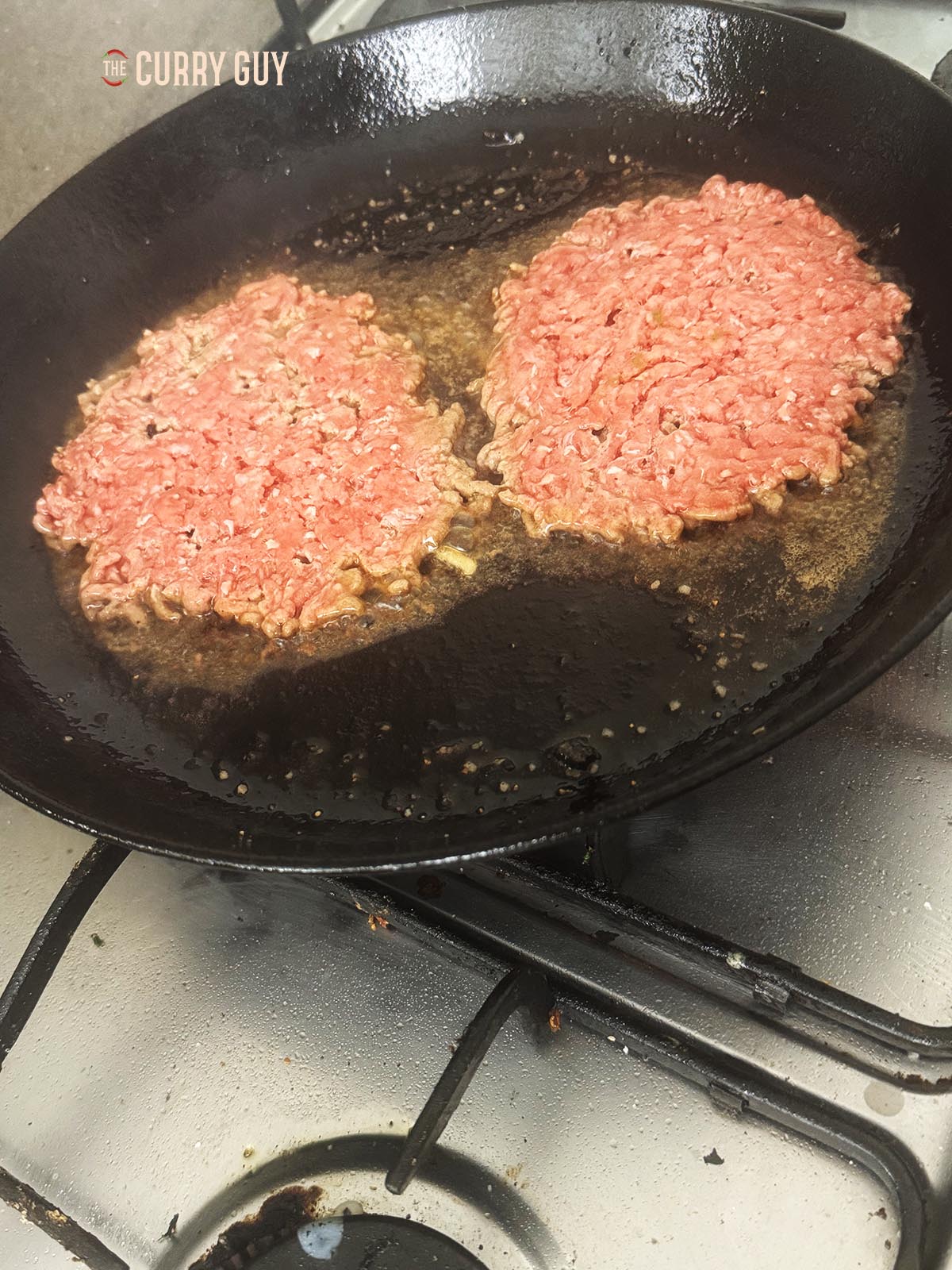 Frying the underside of the burger patties.