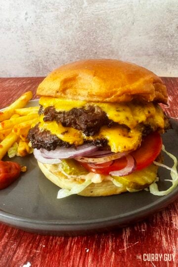 Smash Burger on a serving plate with fries.