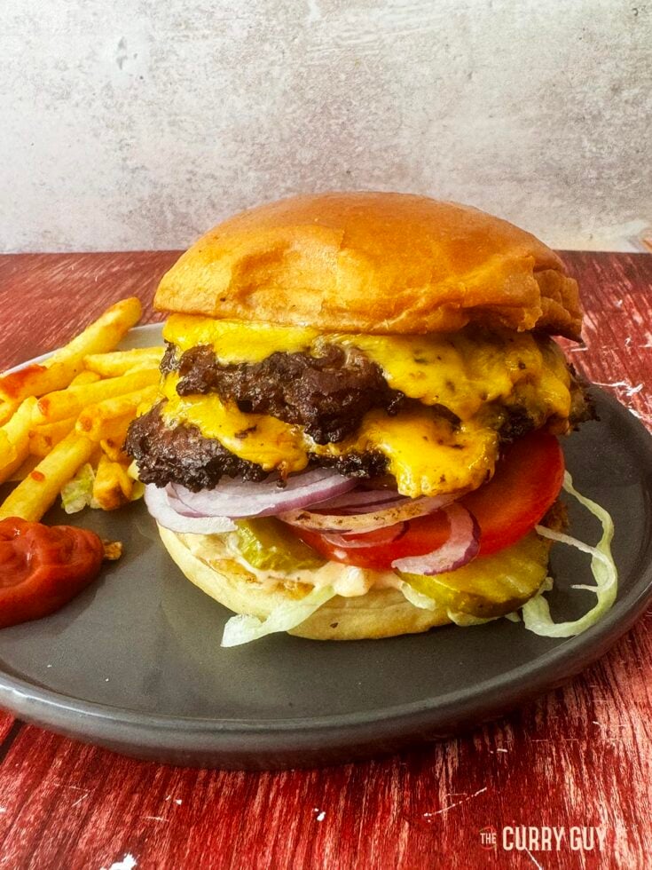 Smash Burger on a serving plate with fries.
