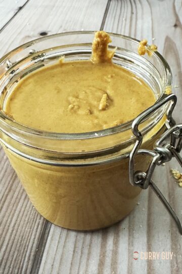 Homemade tahini in a glass jar.