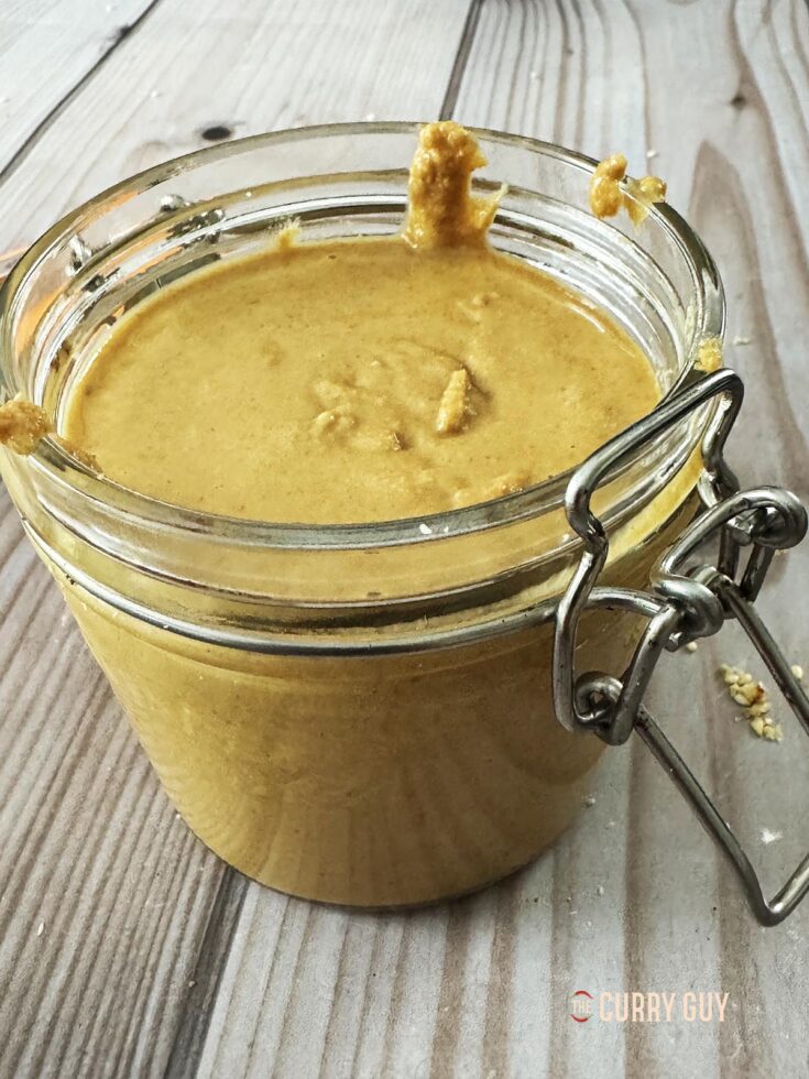 Homemade tahini in a glass jar.