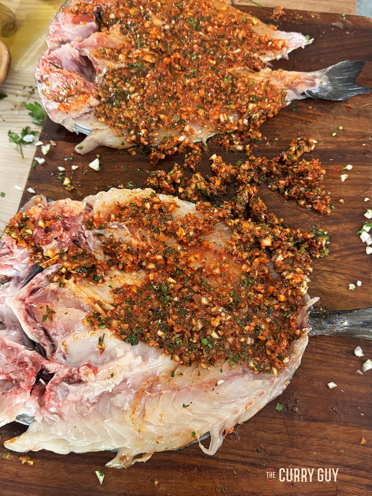 Applying the marinade to the fish.