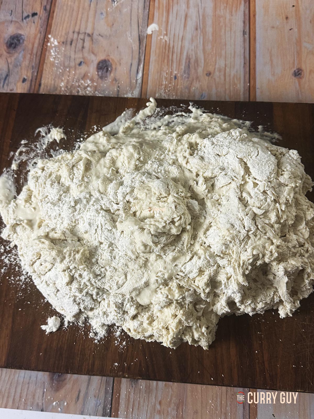 The dough on a work surface ready to knead. 