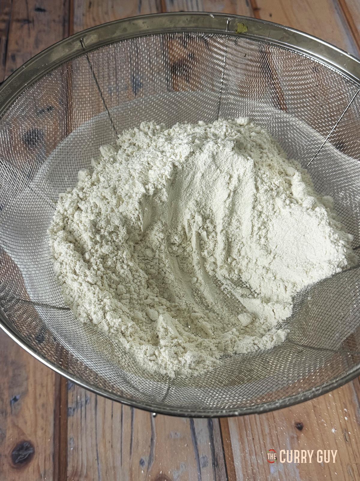 Adding about 500g of flour to the starter and water mixture.