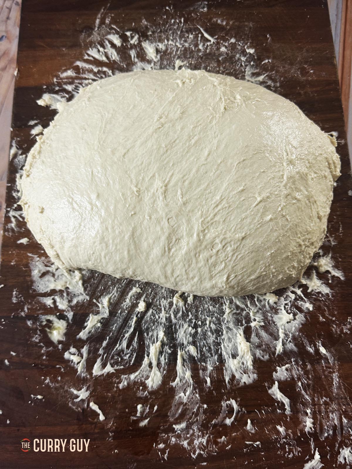 A large dough ball on a work surface. 