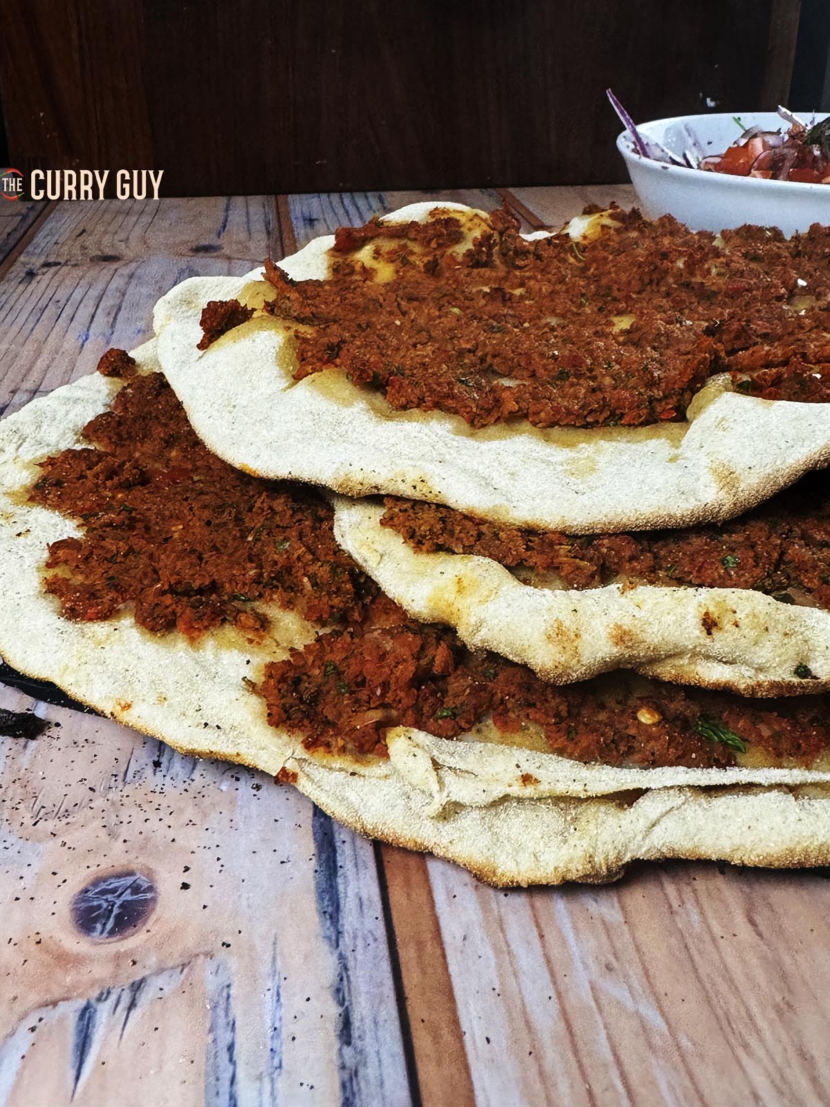 A stack of lahmacuns ready to serve.