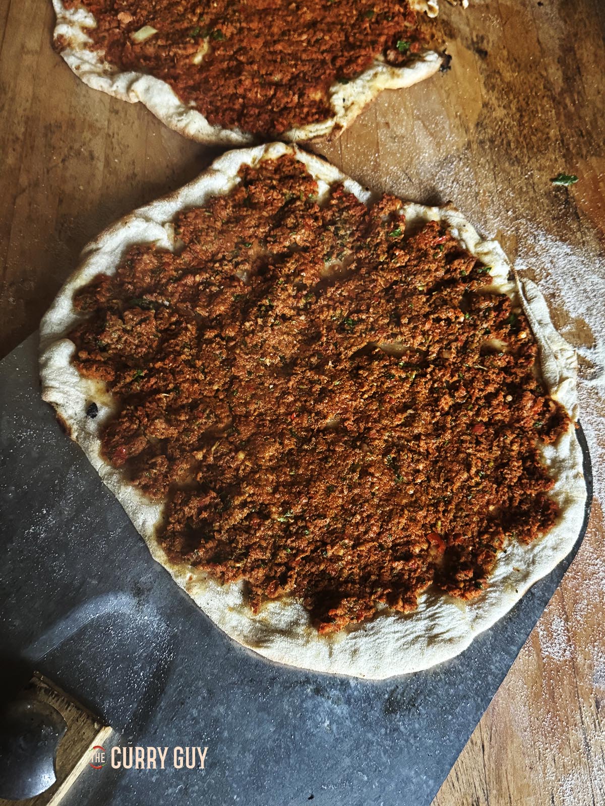 A finished lahmacun resting on the countertop. 
