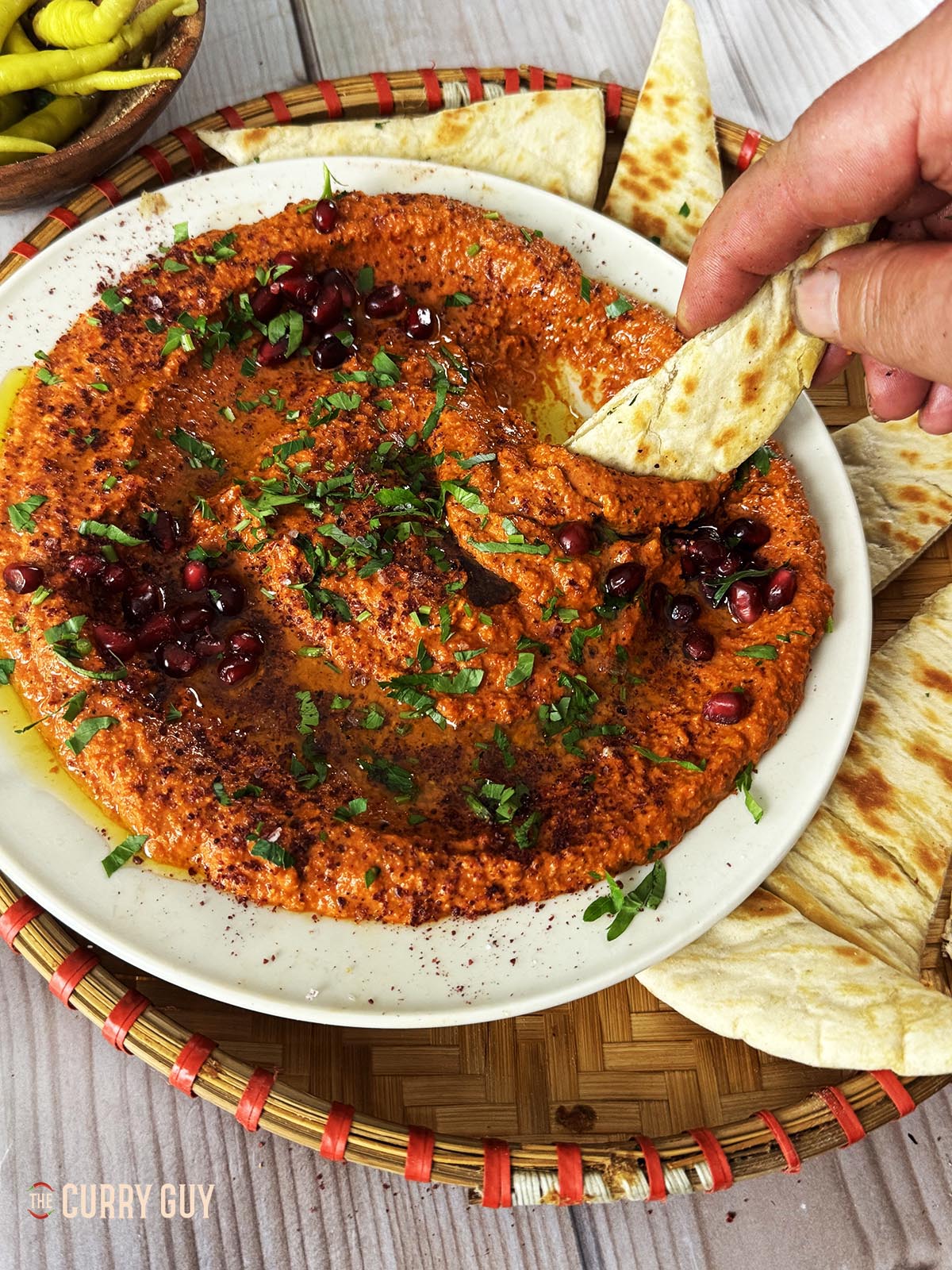 Dipping a pita into the muhammara.