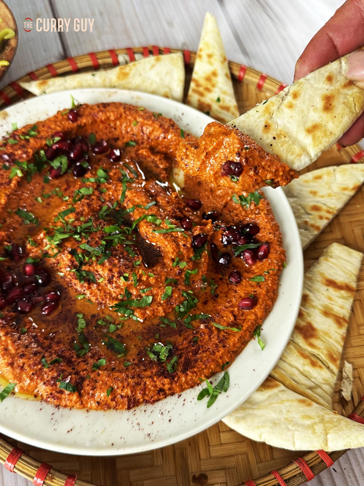 Dipping a pita into the muhammara