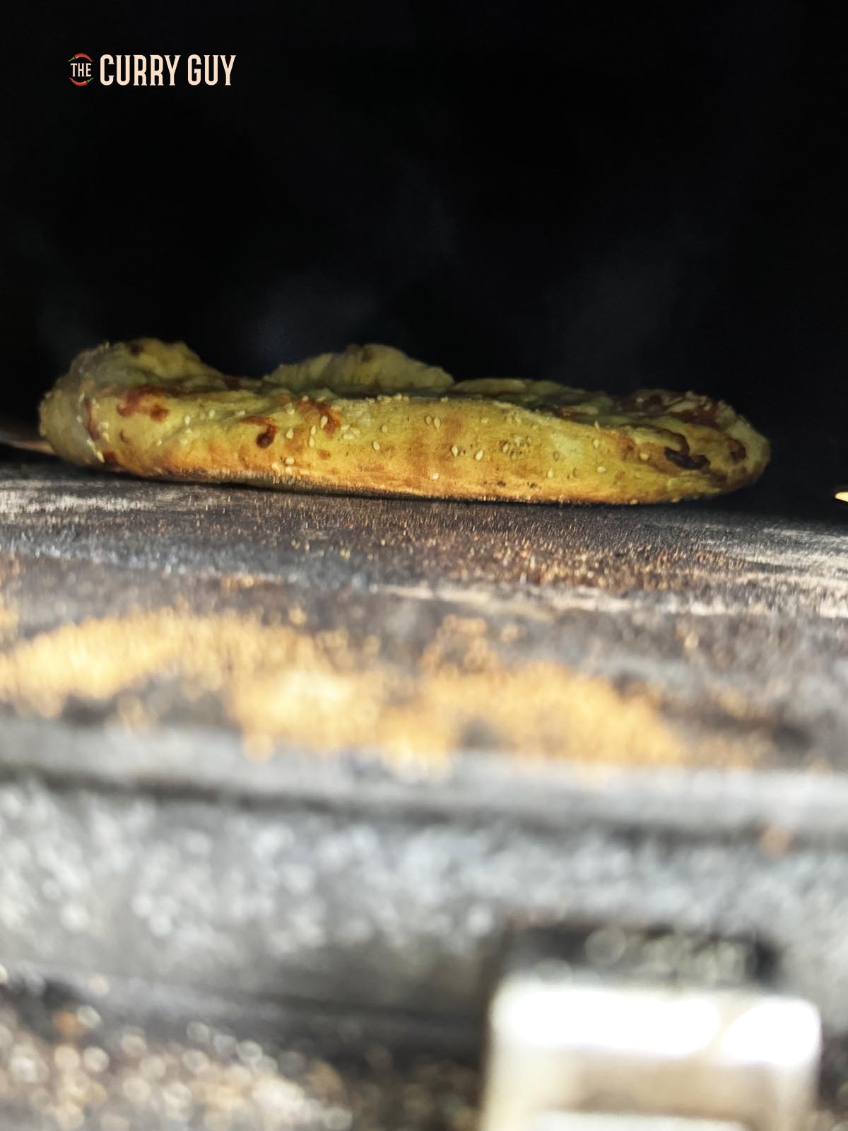 Cooking a pide in a wood burning oven.