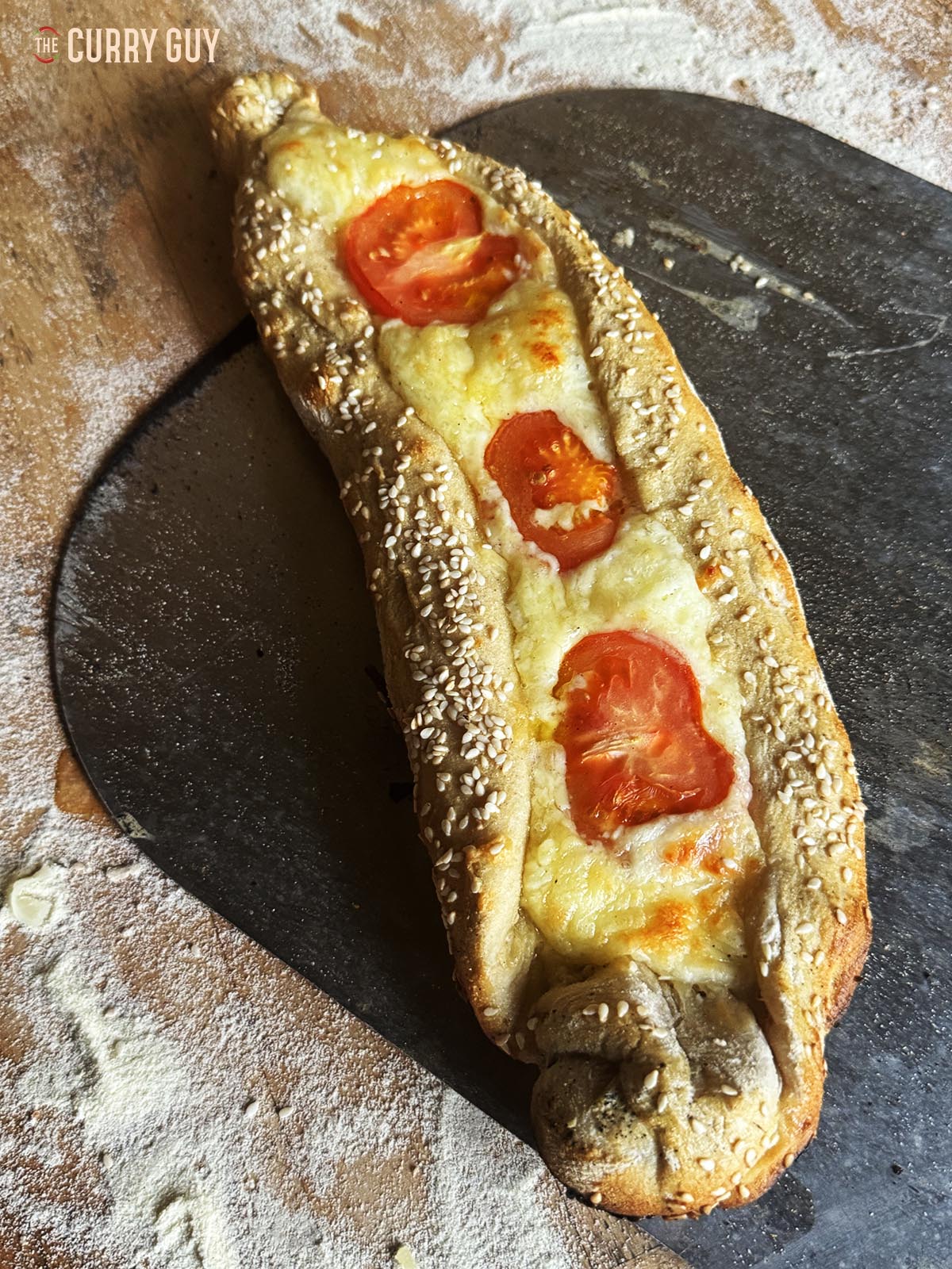 A pide filled with cheese and tomato.