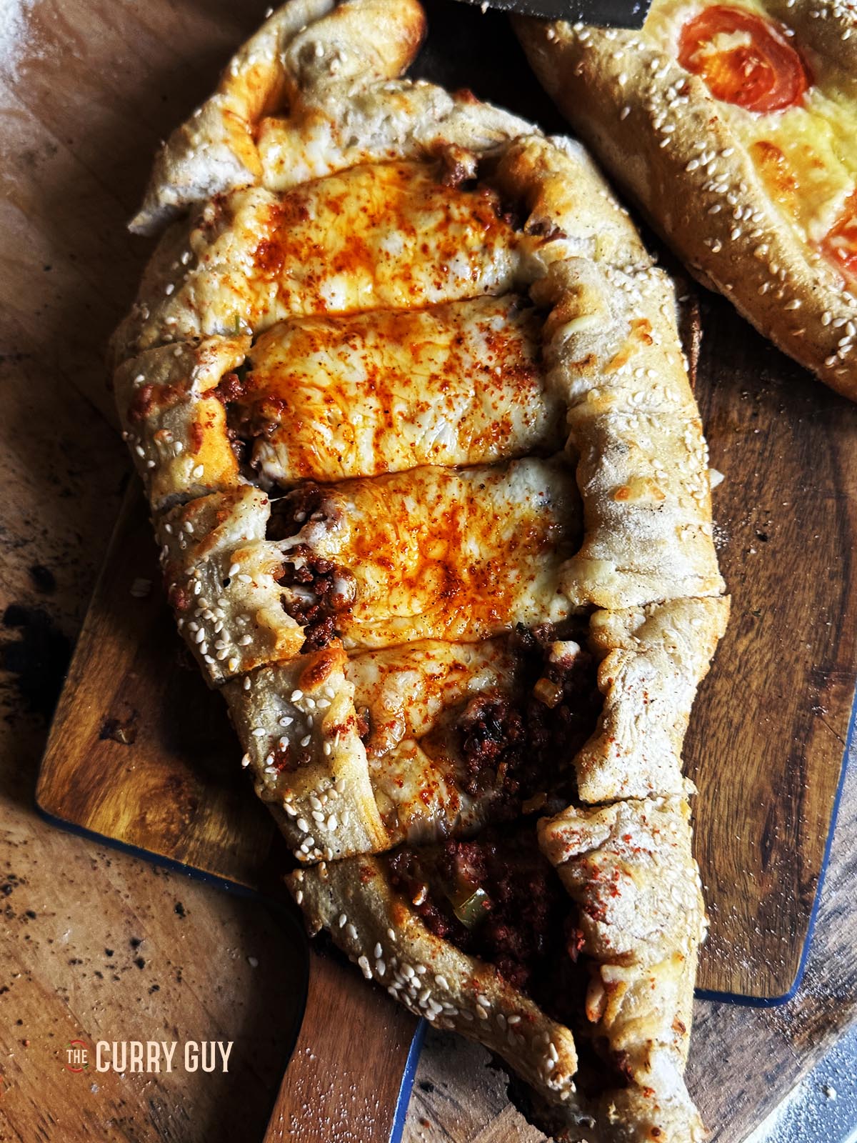 A pide sliced into pieces for serving.