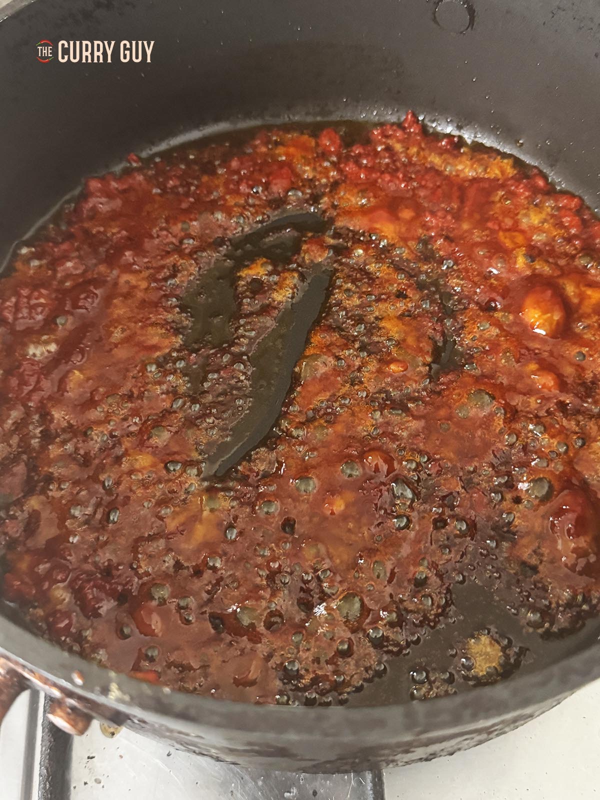 Melting the jaggery in a pan until thick.