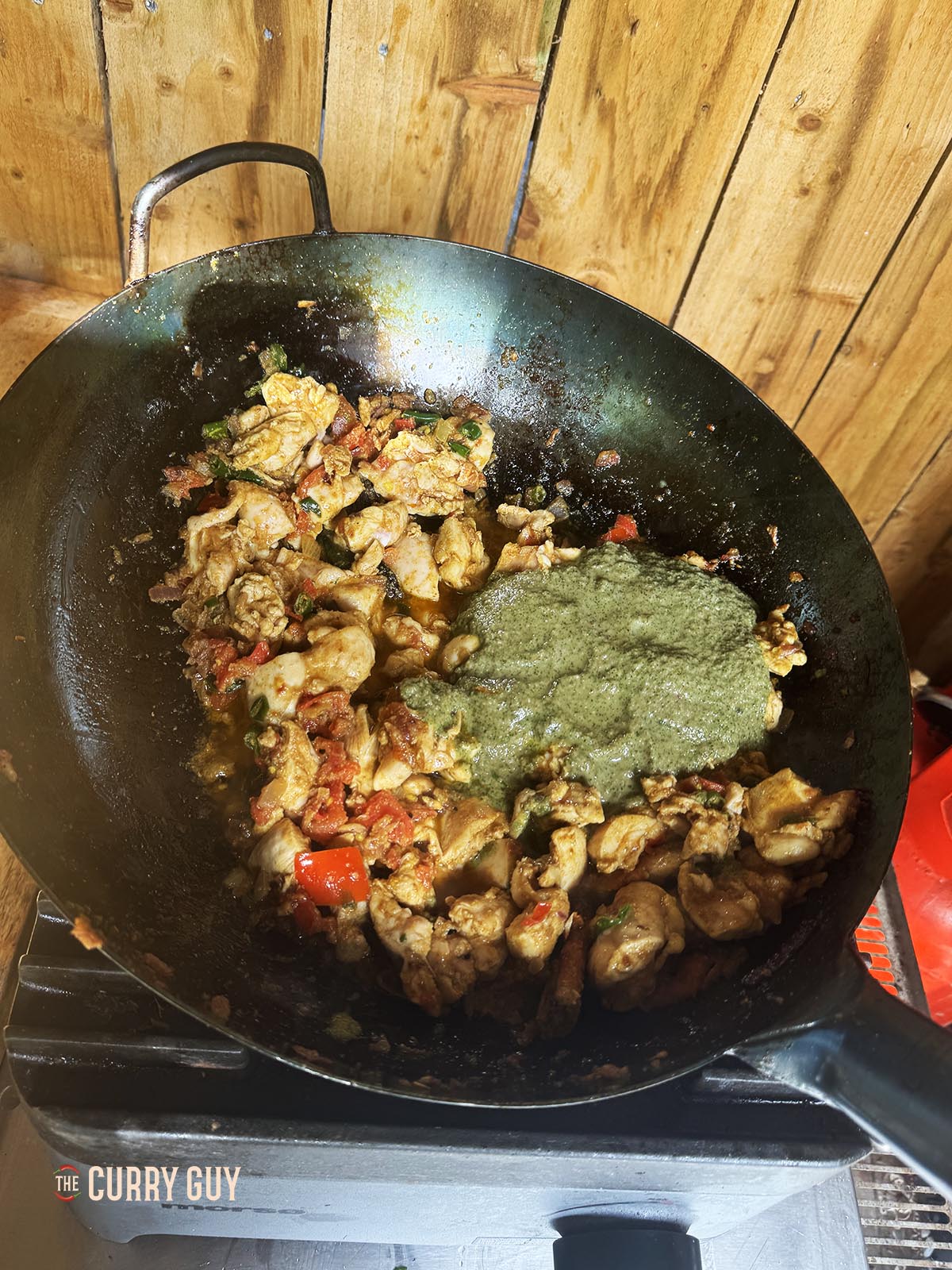 Adding the spice paste to the pan.