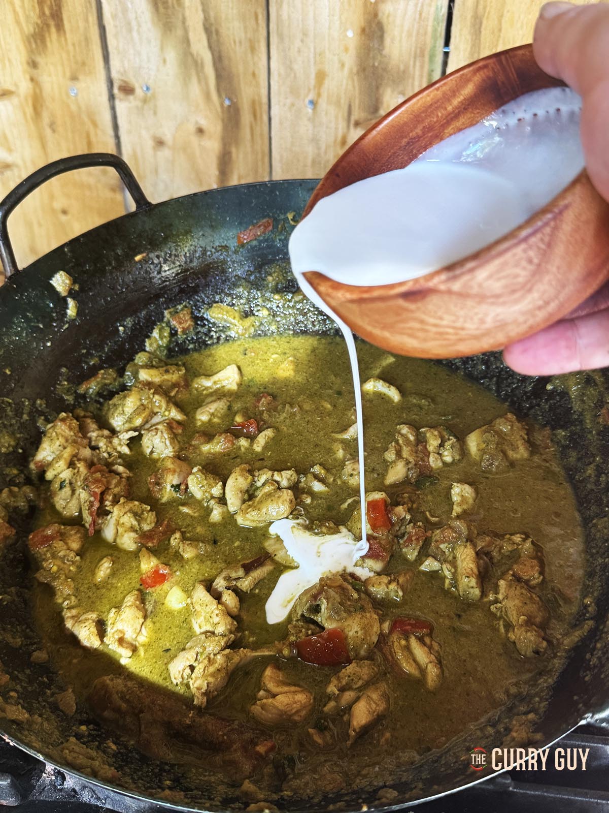 Pouring in the coconut milk.