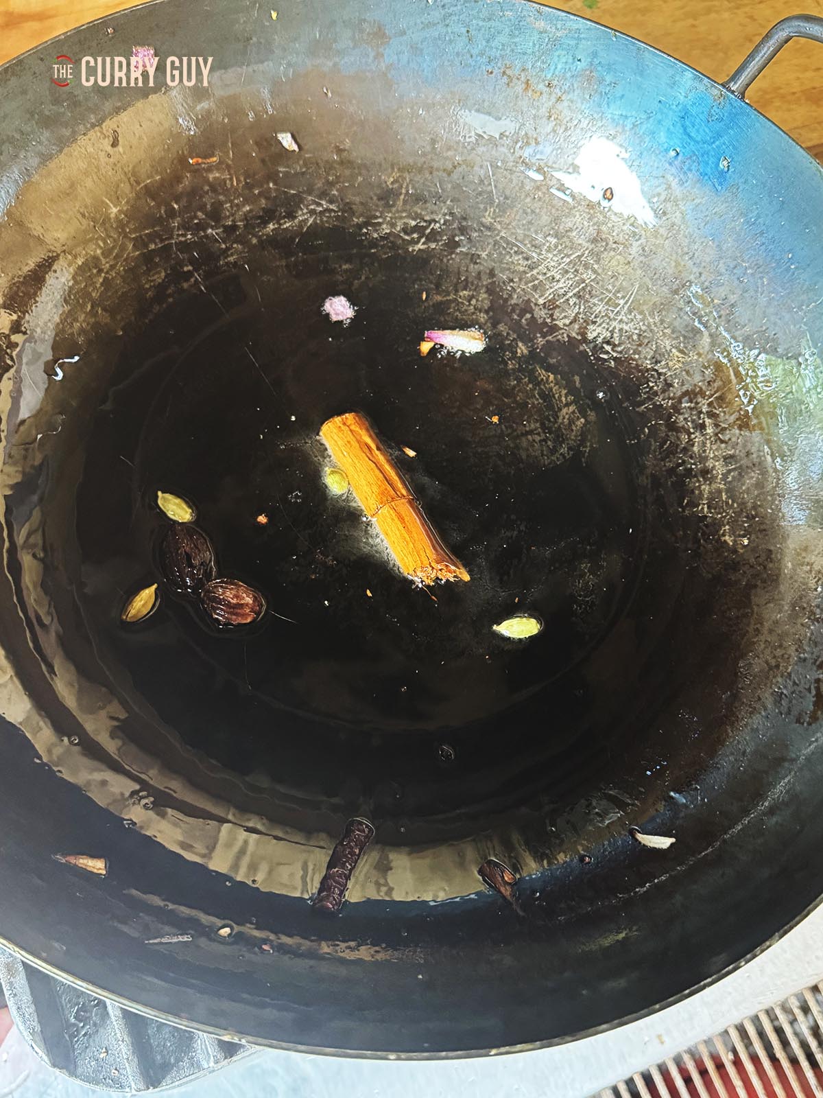 Infusing the whole spices in oil to infuse their flavour into the oil. 