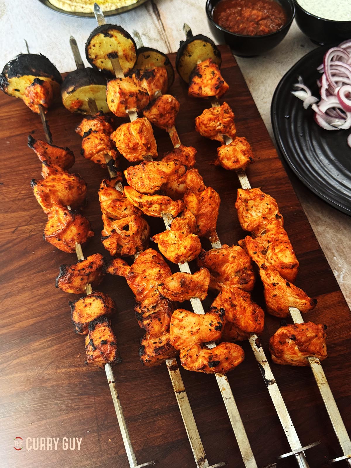 Turkish chicken kebabs on skewers after being cooked over fire.