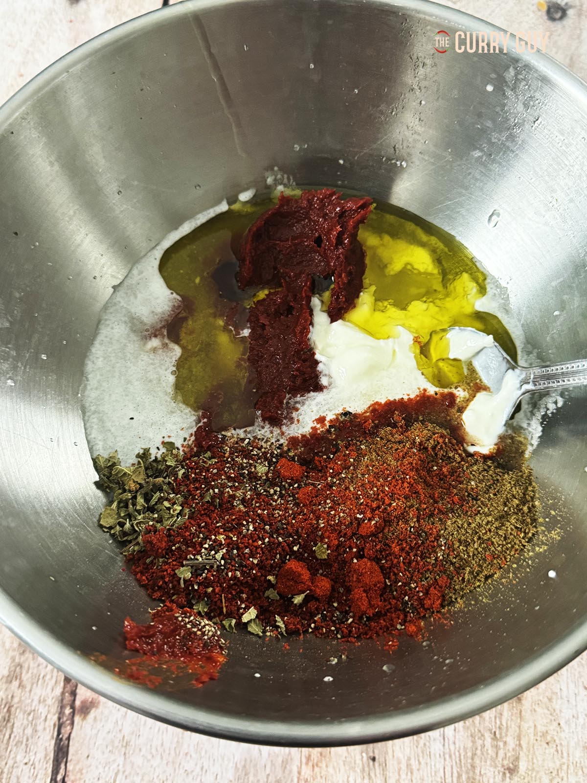 Placing the marinade ingredients in a mixing bowl to whisk.